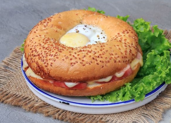 Fried Eggs in a Bagel with Sausages and Cheese