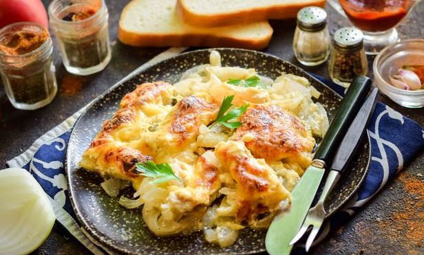 Pollock Baked in Mustard-Mayonnaise Sauce, with Onions and Cheese